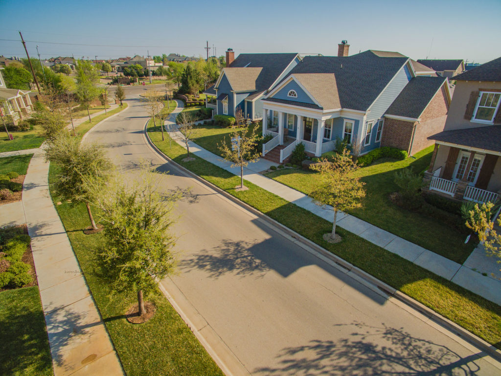 An aerial residential real estate photo showcasing the property and street it is located on.